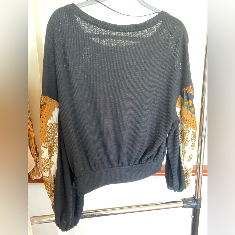 Free people long sleeve top with detailed sleeves.